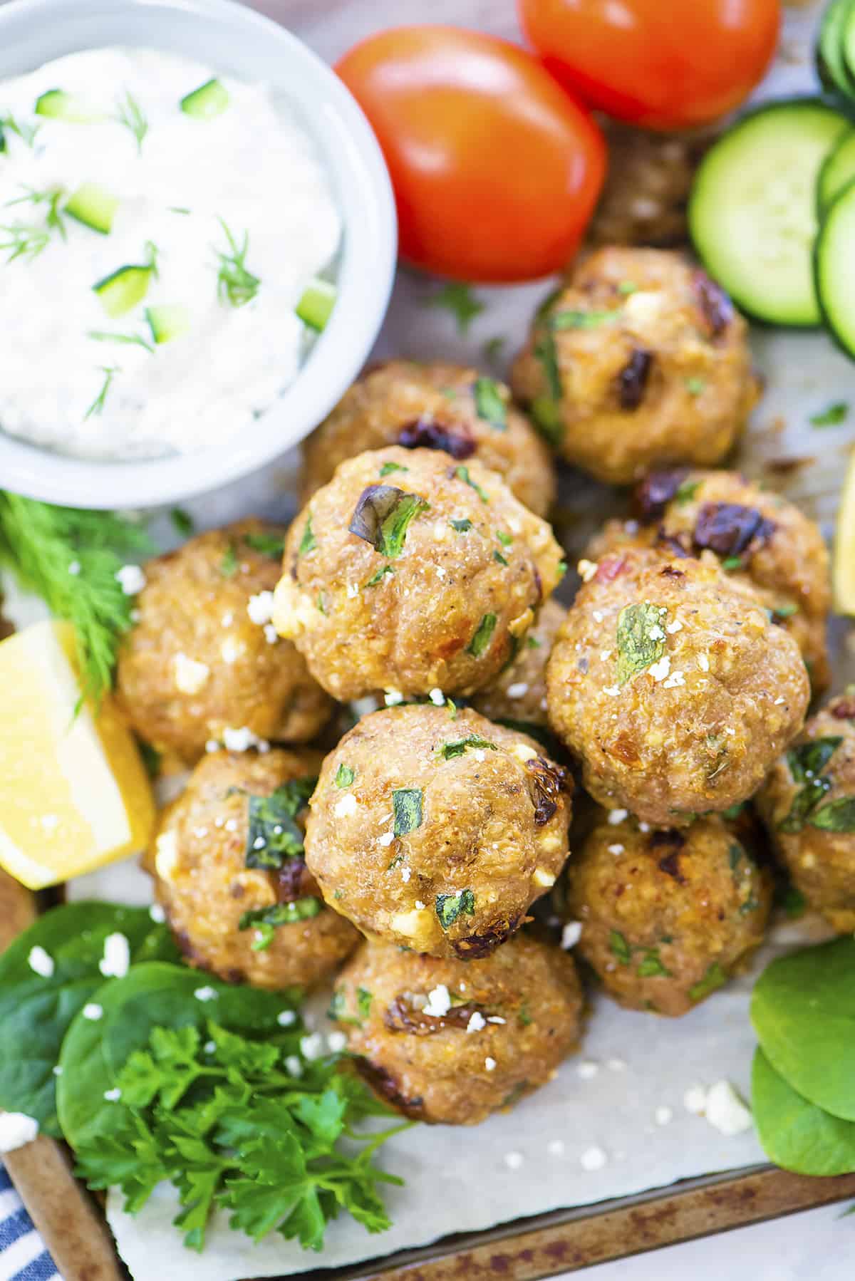 Overhead view of turkey meatballs on platter with tzatziki.