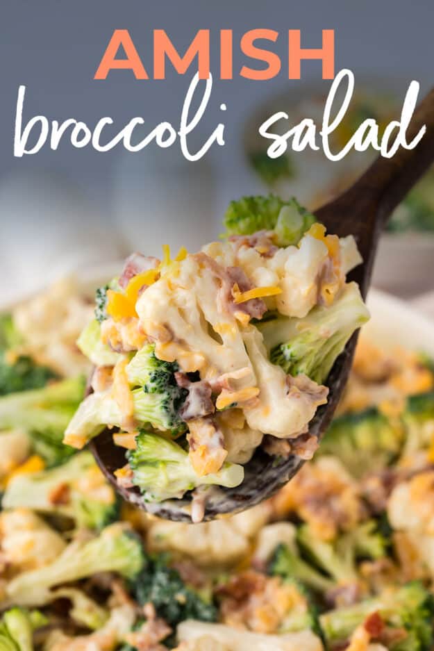 Broccoli salad on wooden spoon.