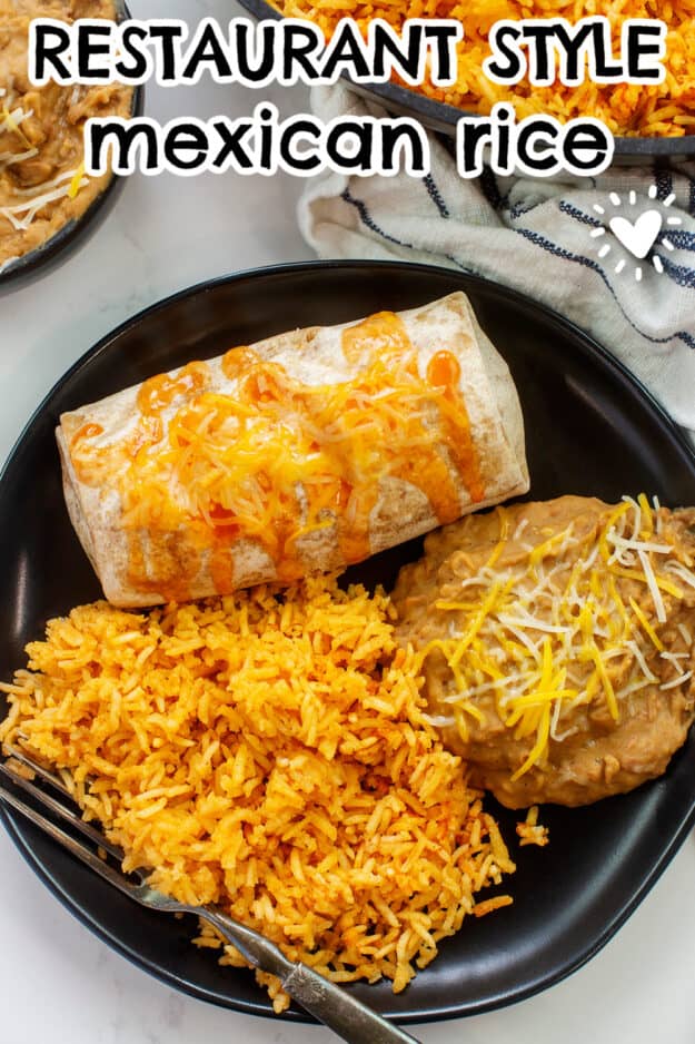 Mexican rice on black plate with chimichanga and beans.