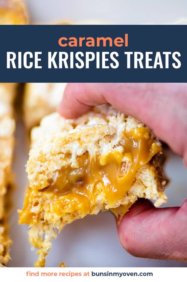 Hand grabbing a rice krispies treat from the pan.