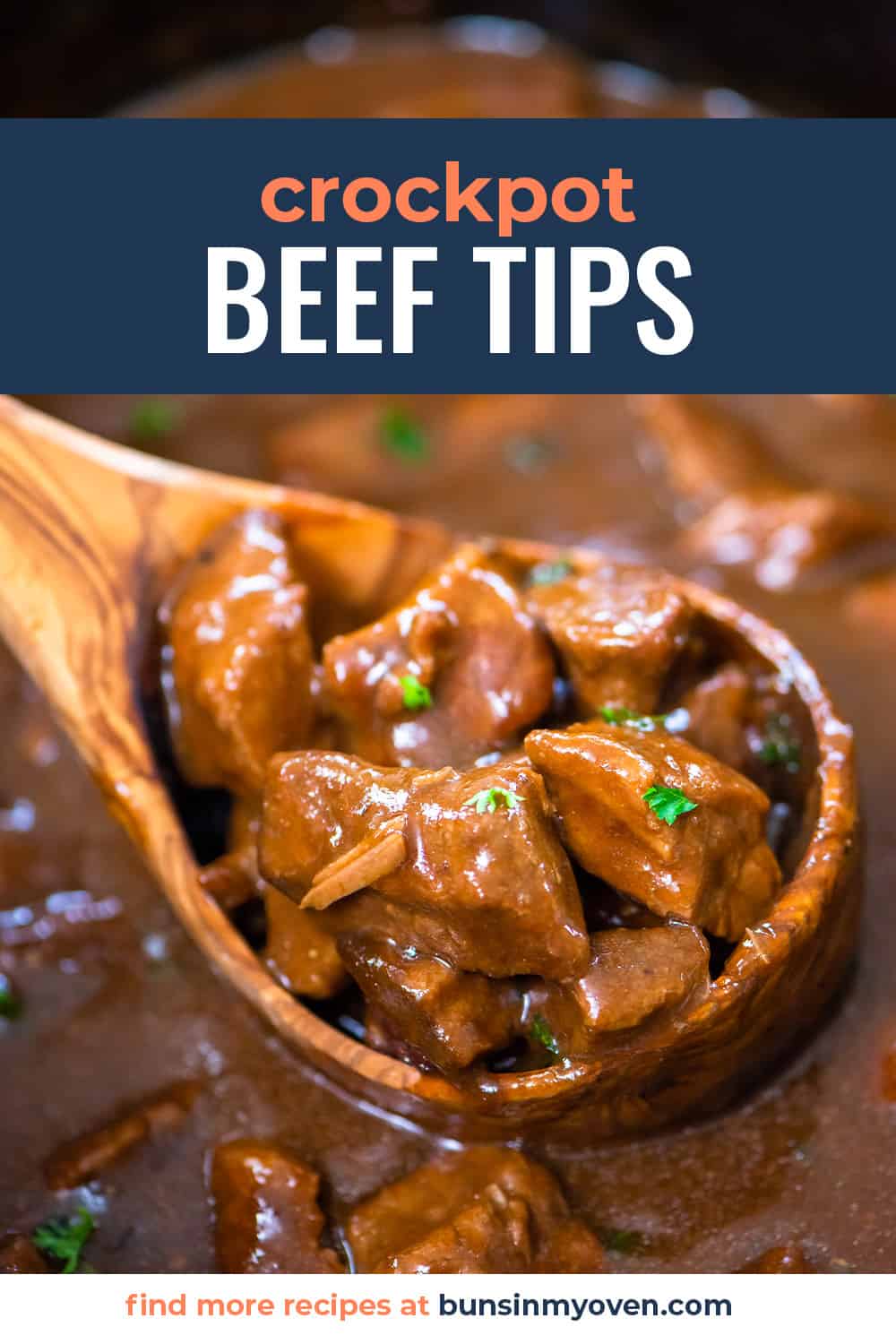 Crockpot beef tips and gravy in wooden ladle.