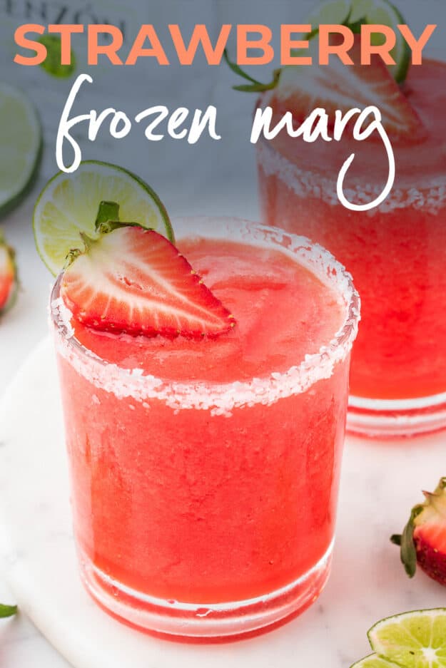 Strawberry margarita in glass with strawberry garnish.