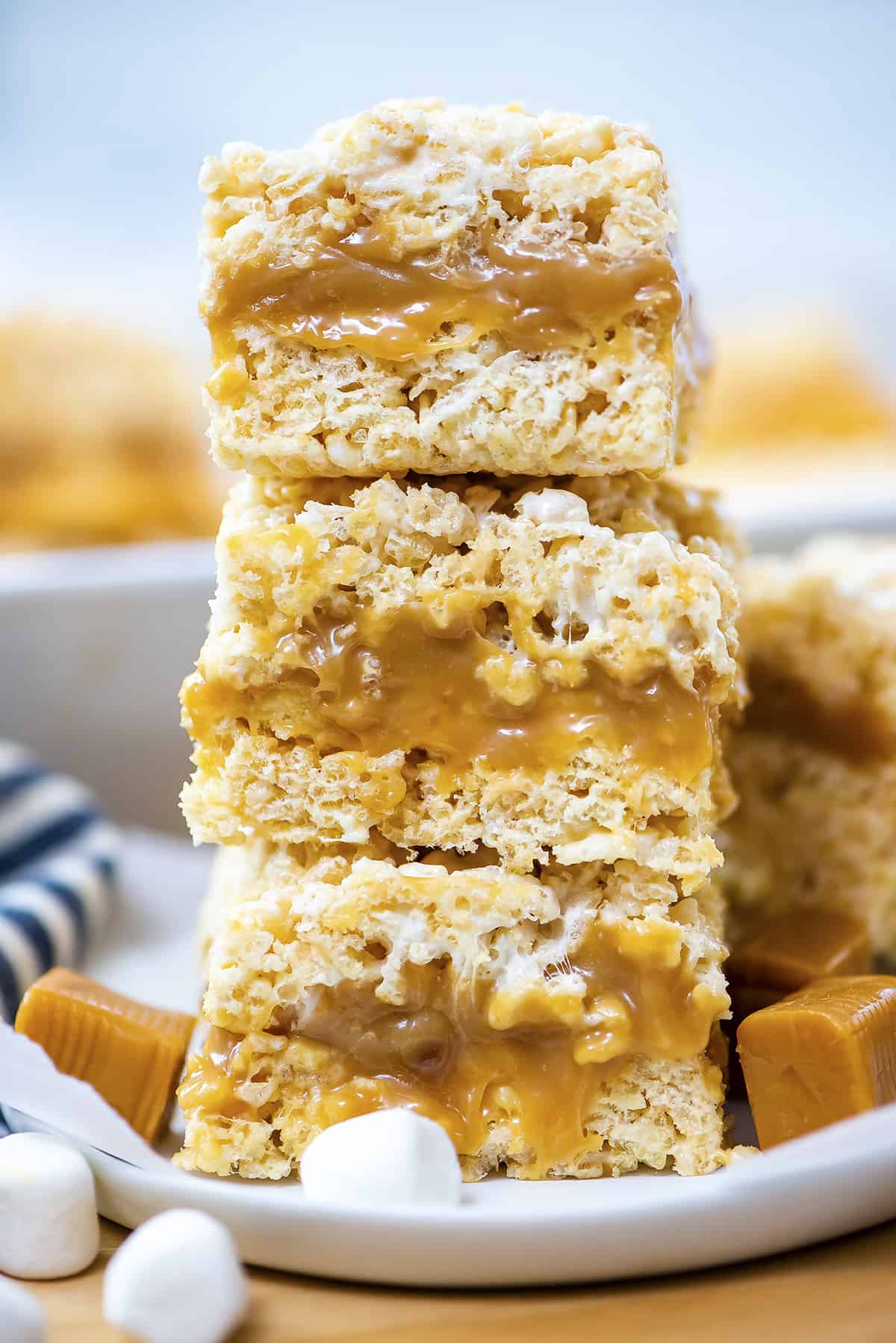 Stack of caramel rice krispies treats on plate.