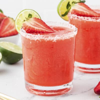 Frozen strawberry margaritas in glasses.