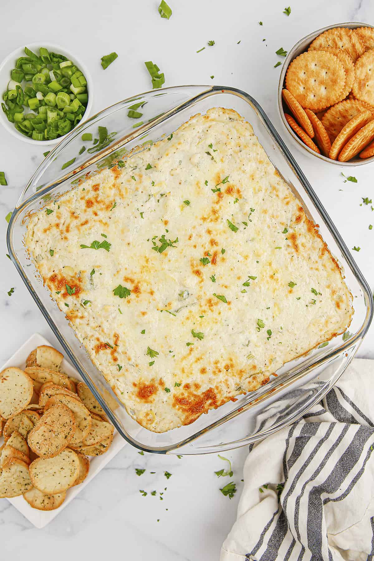 Baking dish full of artichoke crab dip.