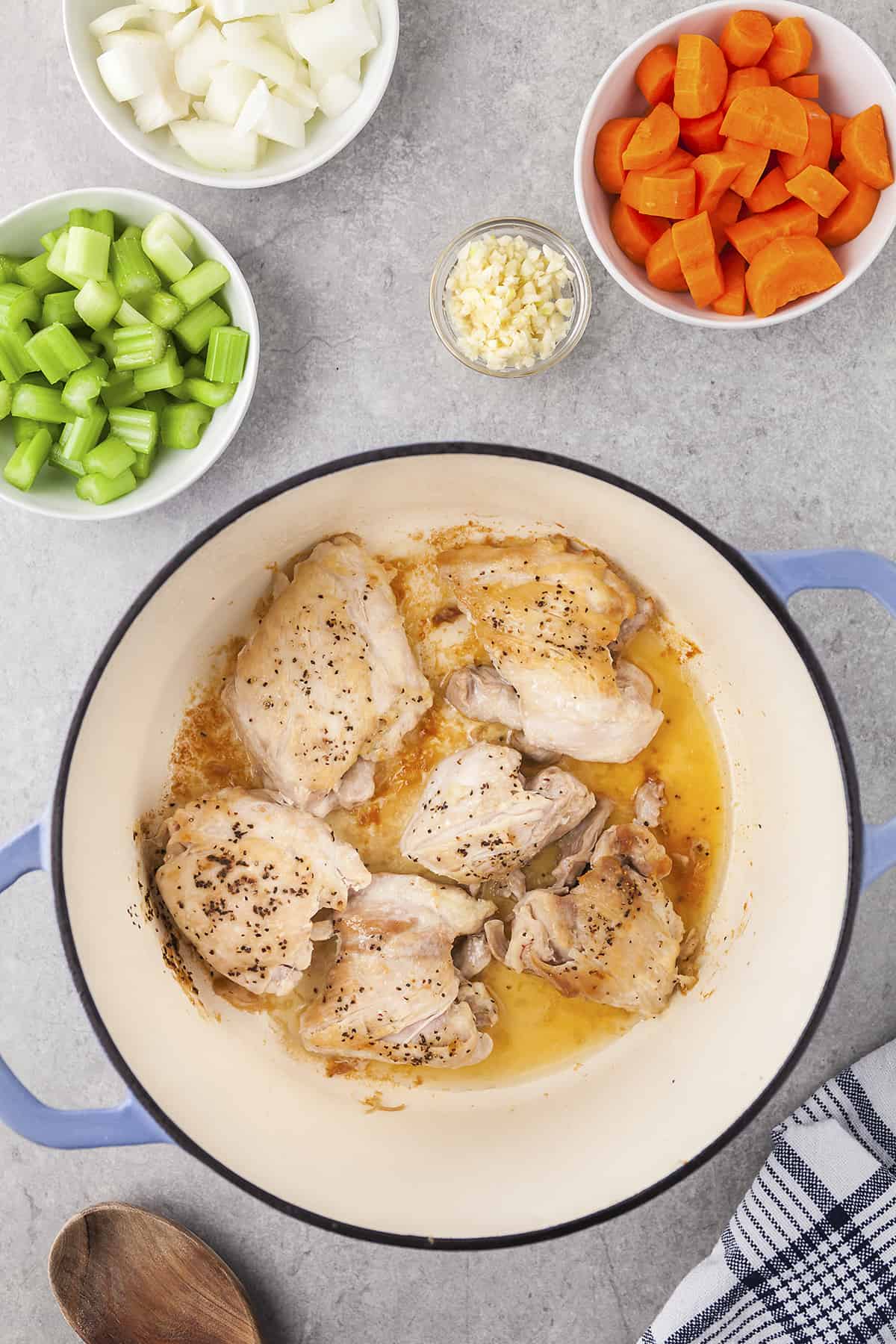 Chicken thighs browning in a dutch oven.