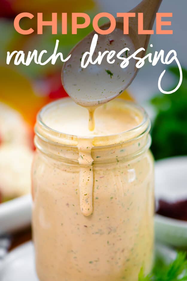 Ranch dressing being drizzled off of spoon into jar.
