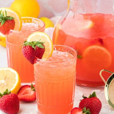 Strawberry vodka lemonade in glasses and pitcher.