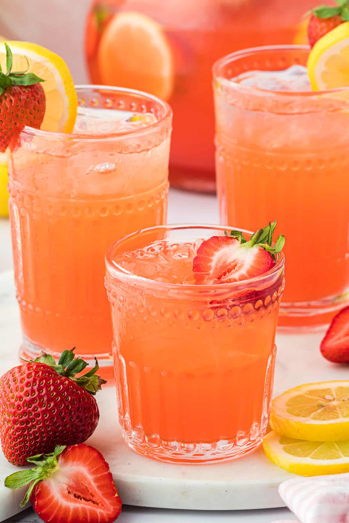 Three glasses full of strawberry lemonade vodka.