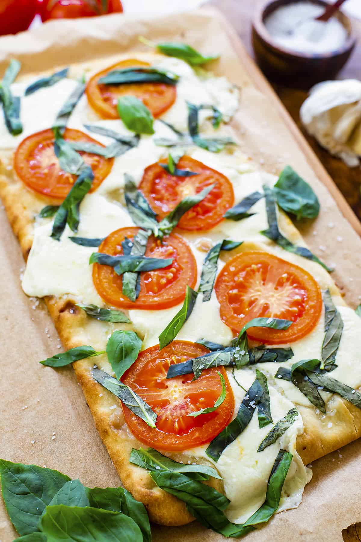 Margherita flatbread on board.