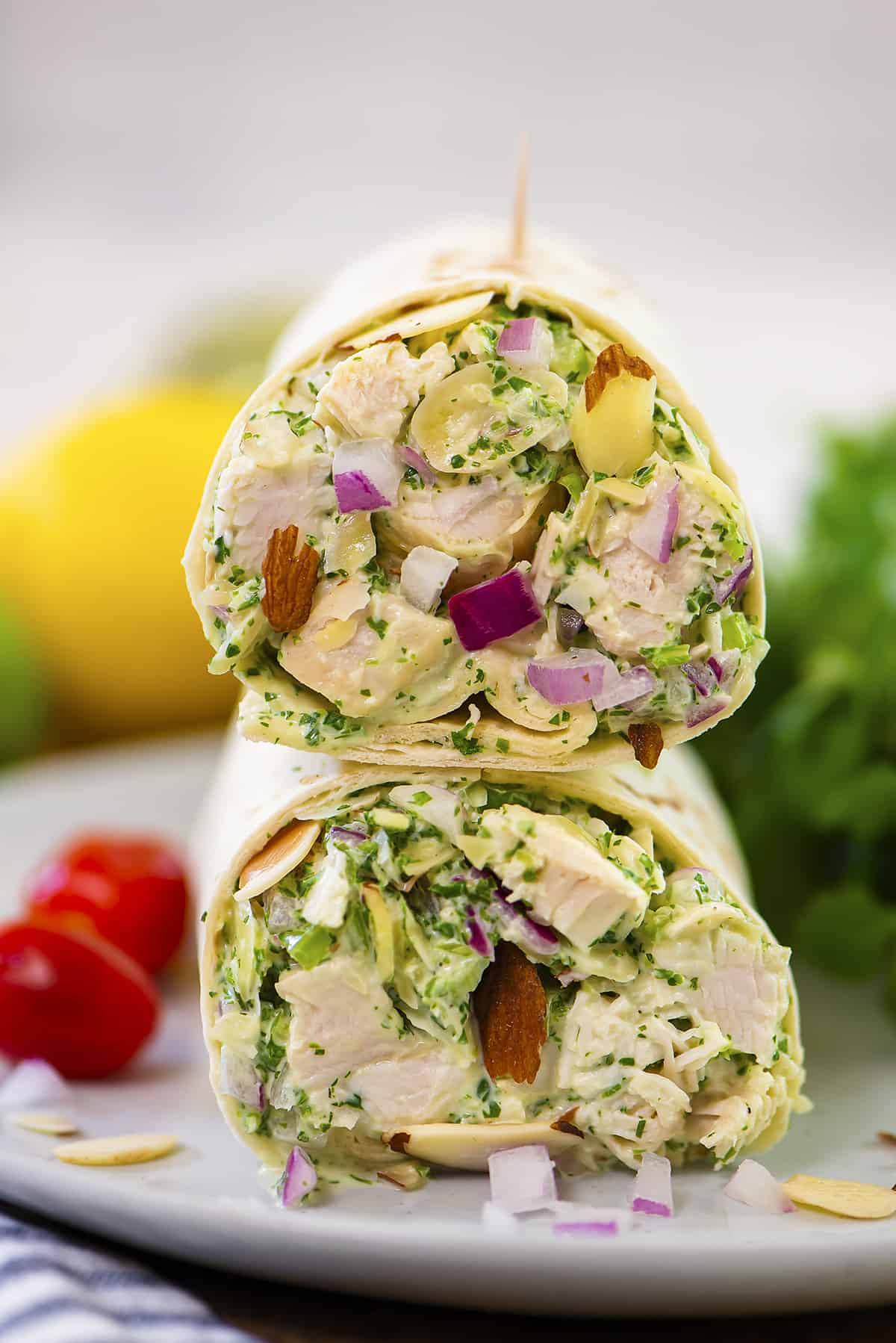 Chicken salad wrapped in a tortilla on plate.