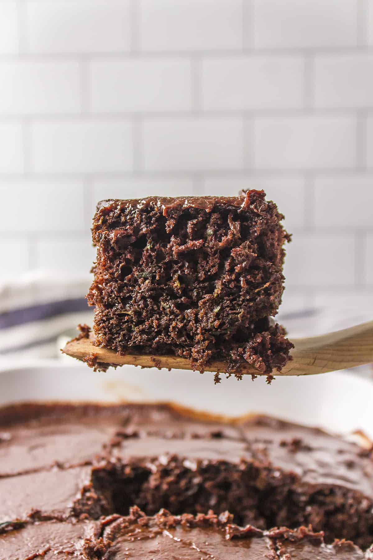 Slice of chocolate cake being lifted out of pan on a spatula.