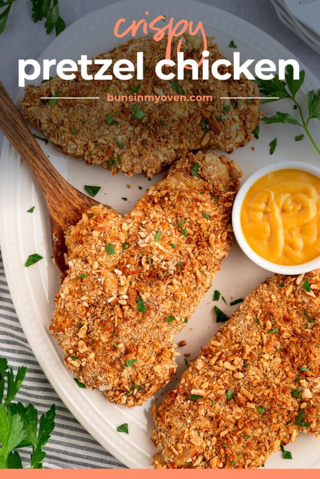 Pretzel crusted chicken on white platter.