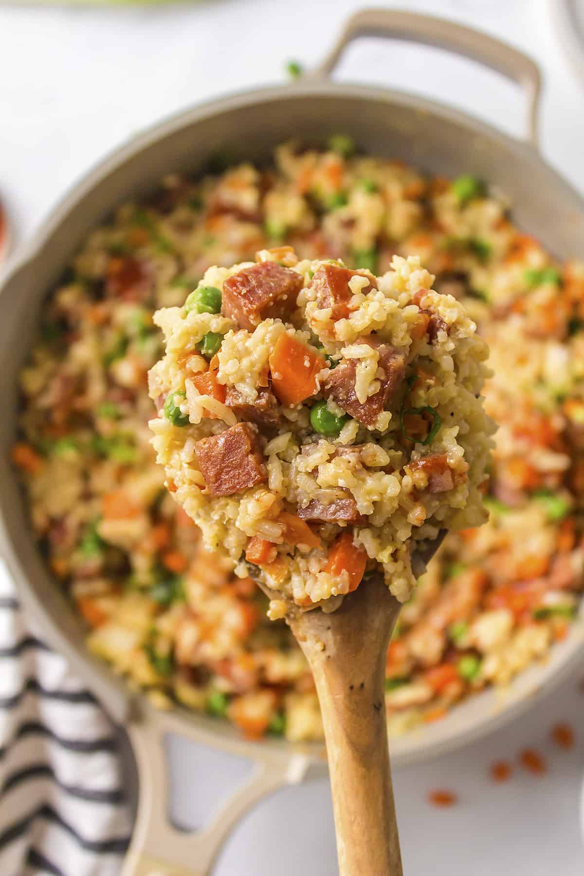 Overhead view of rice with spam in skillet.