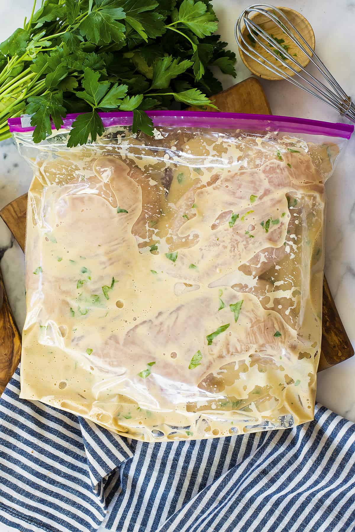 Chicken in marinade in plastic bag.