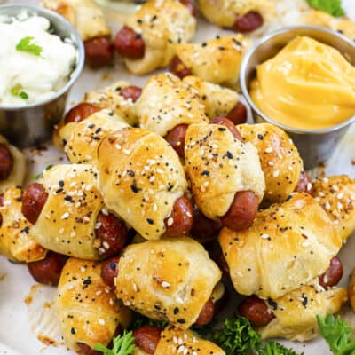 Close up of pigs in a blanket on baking sheet.