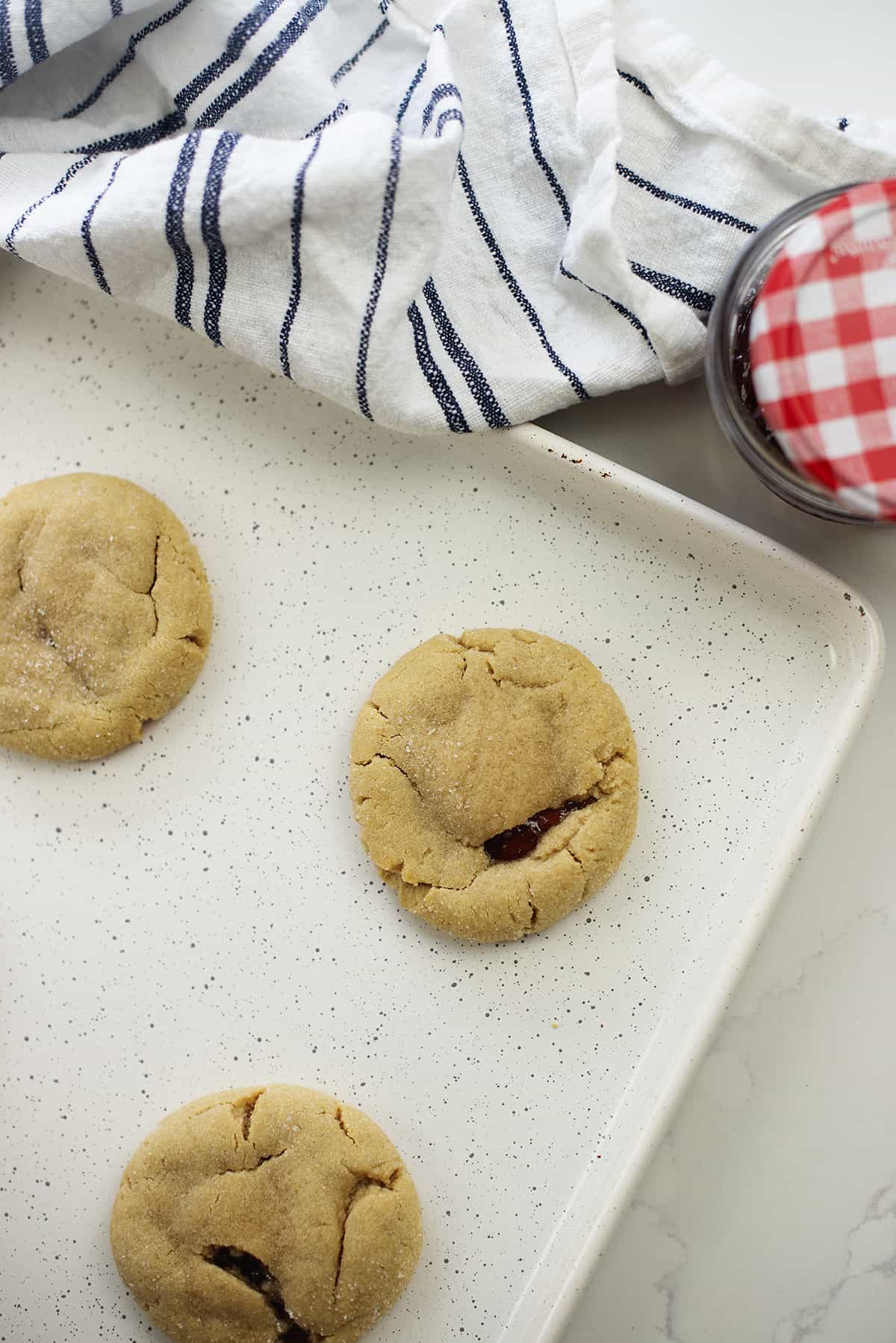 Overhead view of peanut butter and jelly stuffed cookies.