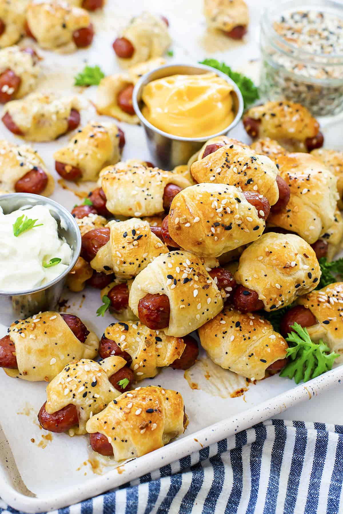 Lil Smokies pigs in a blanket piled on baking sheet.