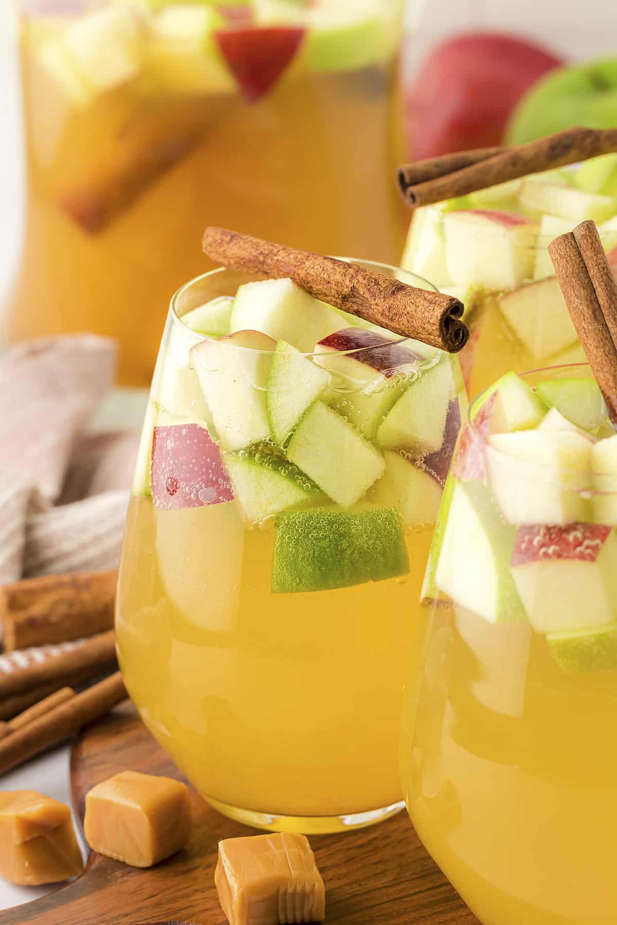 Stemless wine glasses full of caramel apple sangria.