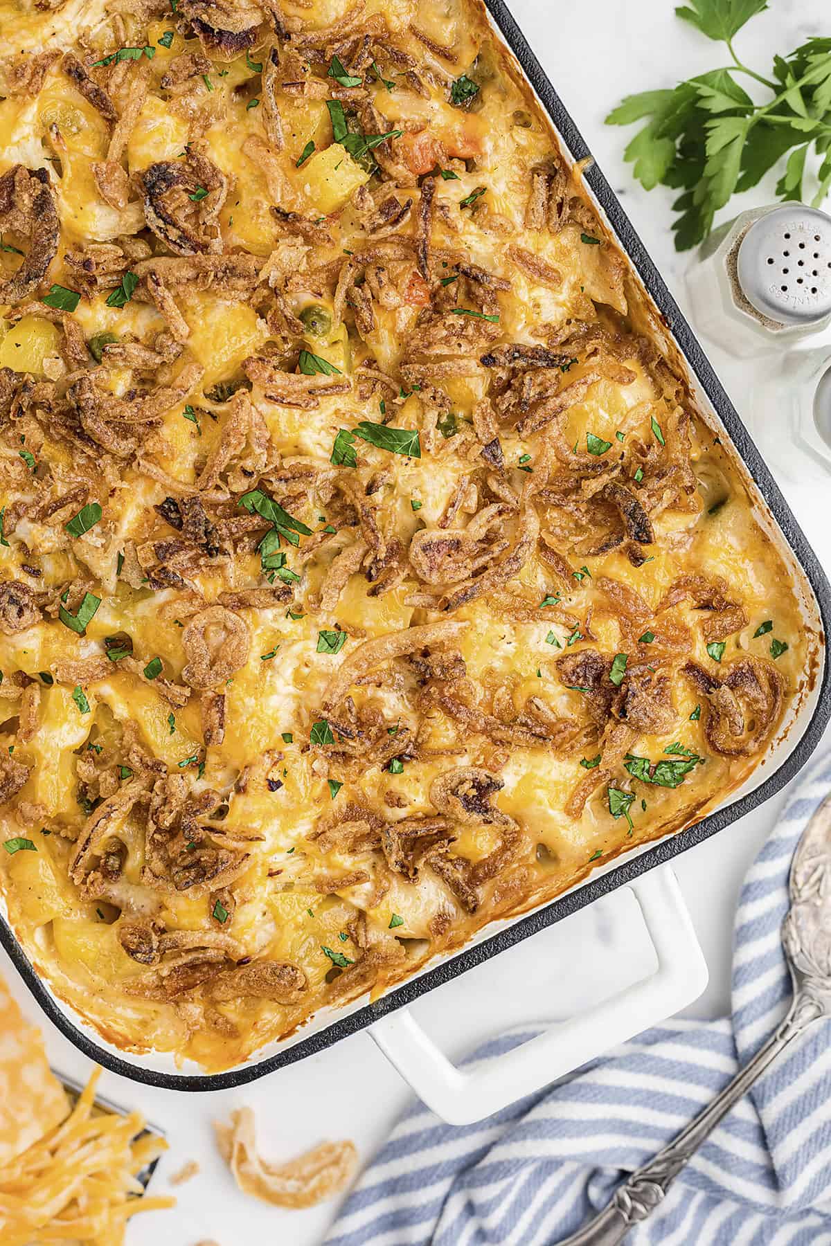 Overhead view of chicken and potato casserole in white baking dish.