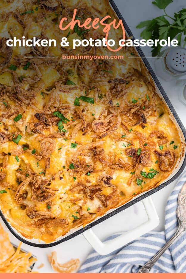 Baking dish full of chicken and potato casserole topped with cheese and onions.