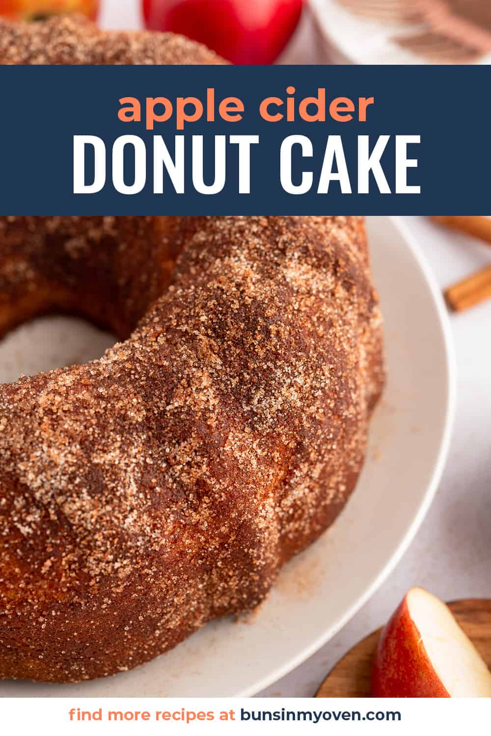 Apple cider donut cake on white plate with text for Pinterest.