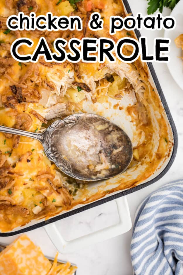 Large spoon in dish full of chicken casserole.