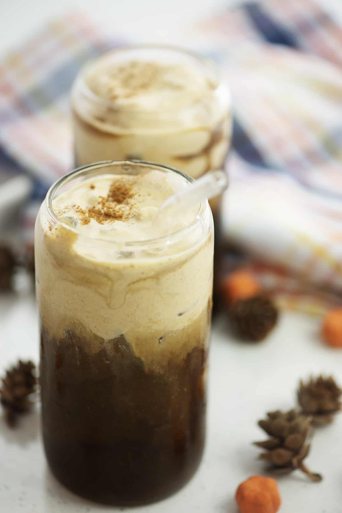 Glass of pumpkin cream cold brew with straw.