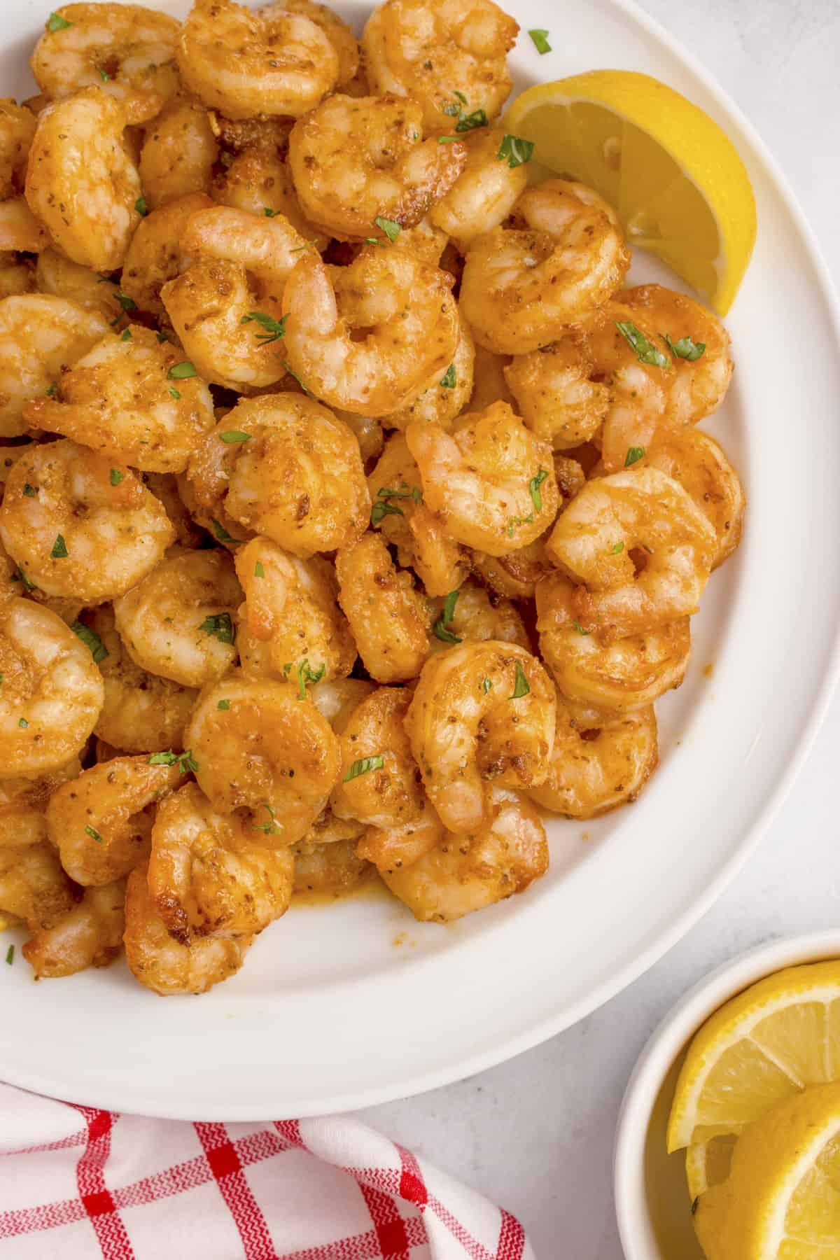 Old Bay shrimp on white plate.