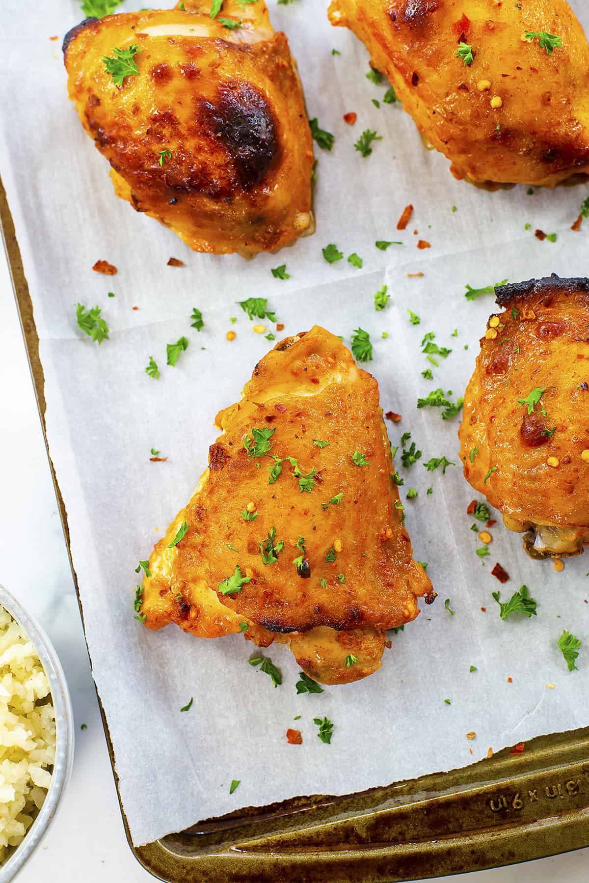 Baked harissa chicken on sheet pan.