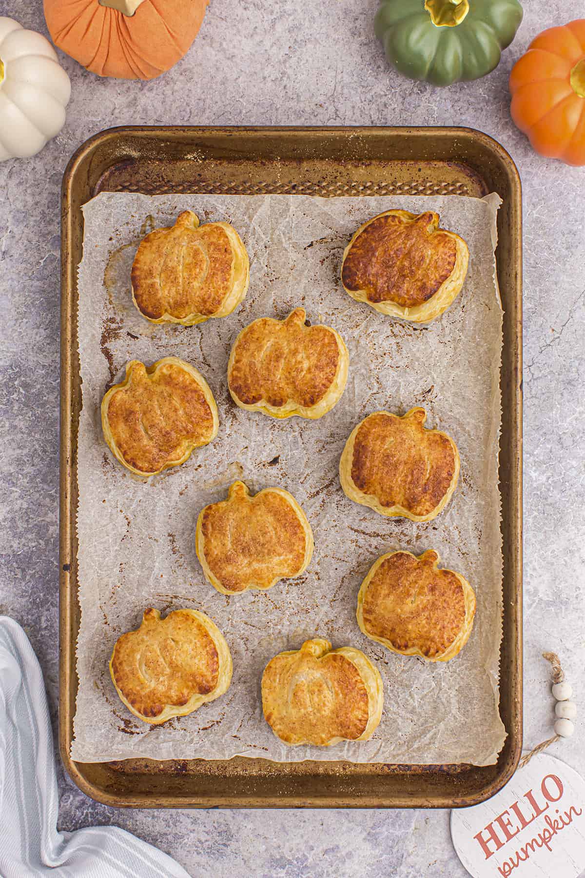Pumpkin puff pastry on baking sheet.