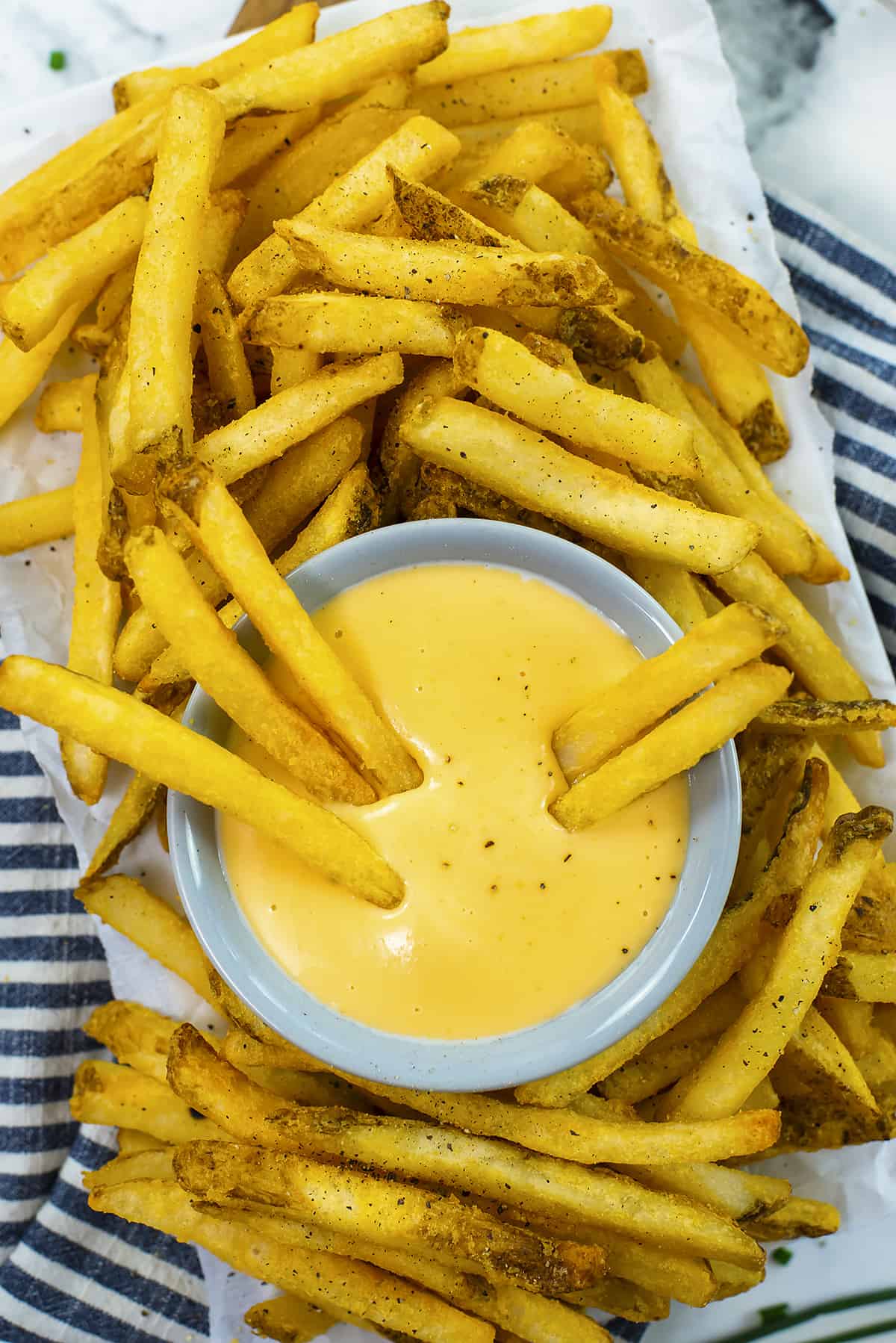 Homemade cheese sauce for fries in small dish.