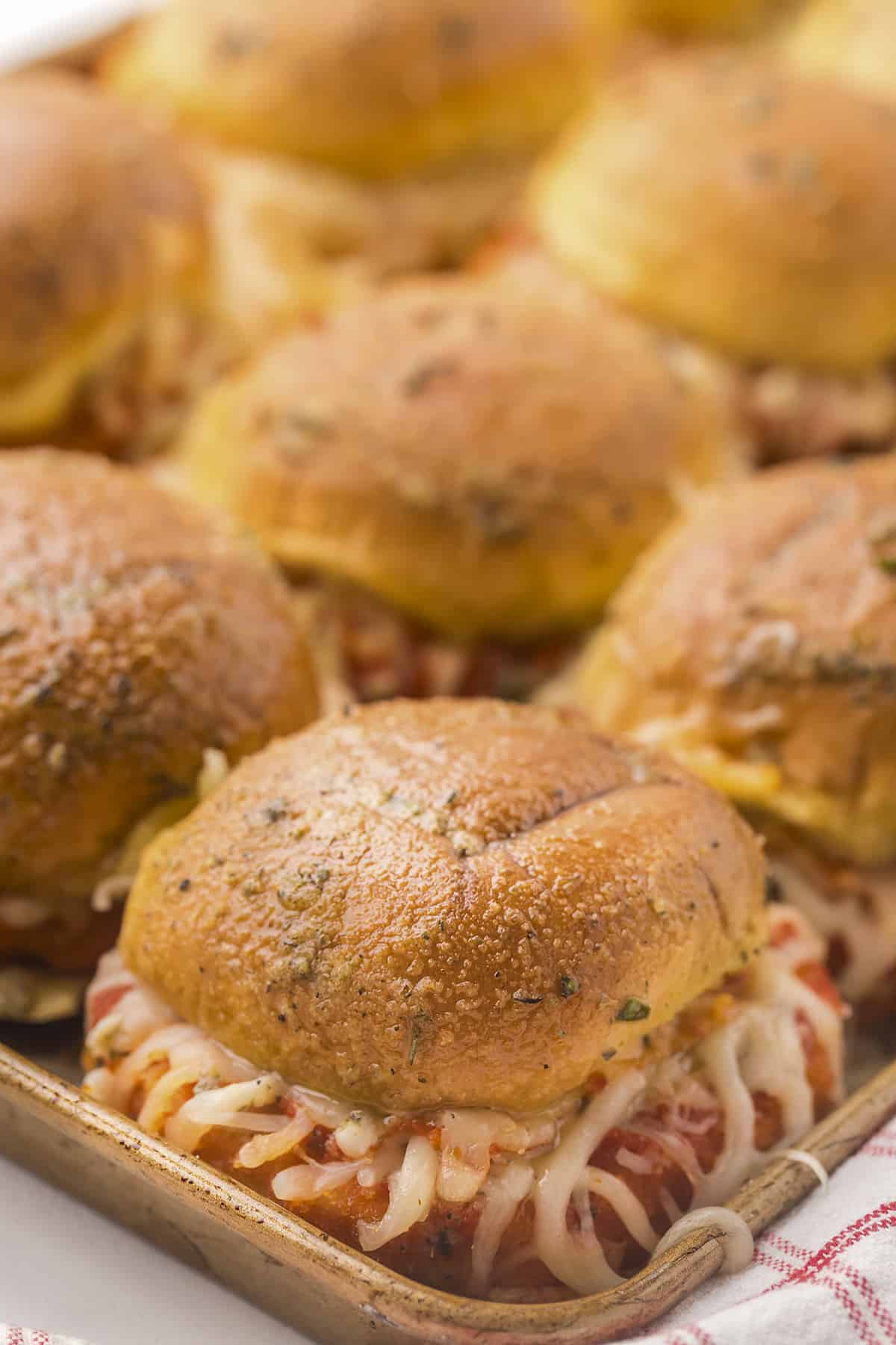 Chicken parmesan sliders on baking sheet.