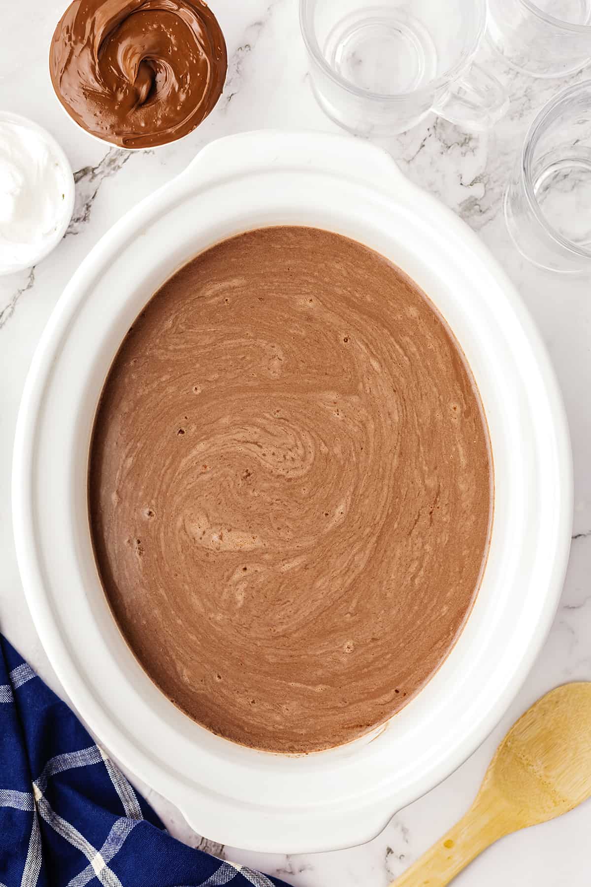 White crockpot full of Nutella hot chocolate.