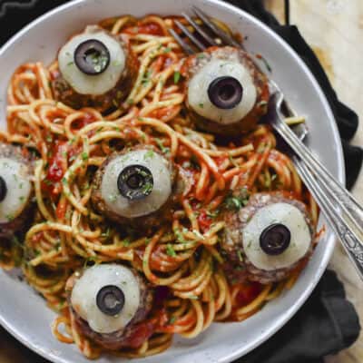 Spaghetti and eyeballs in white bowl.
