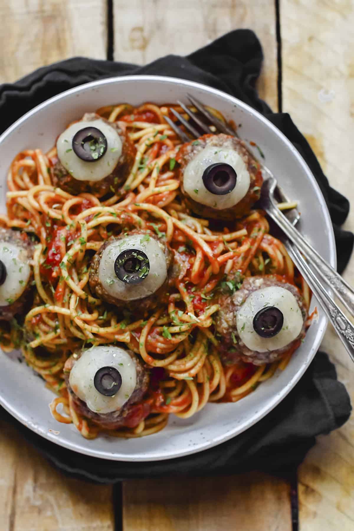 Spaghetti and eyeballs in white bowl.