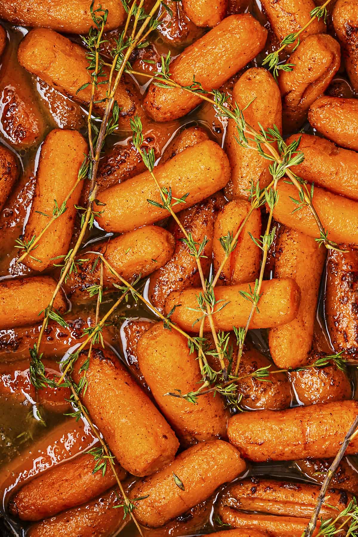Crockpot glazed carrots topped with fresh thyme.