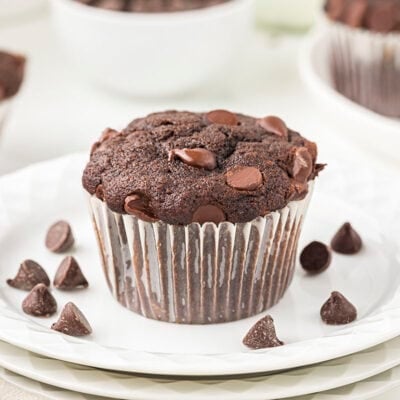 Chocolate banana muffin on white plate.