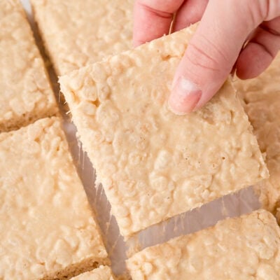 Hand grabbing a brown butter rice krispie treat.