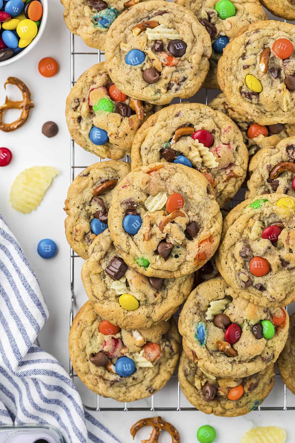 Kitchen sink cookies piled on cooling rack.