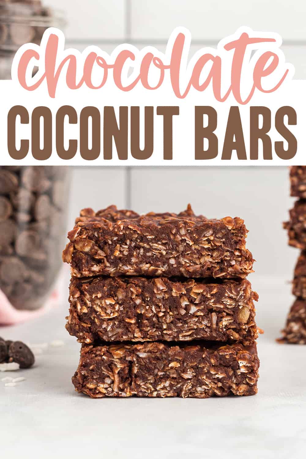 Chocolate Coconut Bars stacked up on counter.