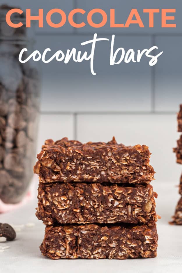 Chocolate coconut bars stacked up on counter.