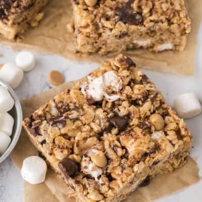 Chocolate peanut butter rice krispie treats sliced and placed on parchment paper.