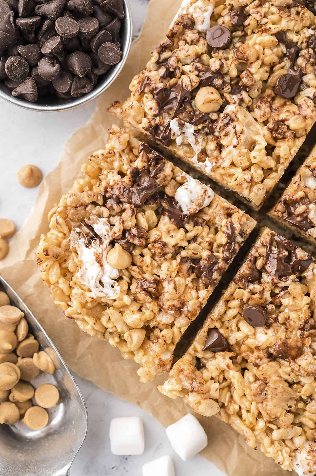 Chocolate peanut butter rice krispie treats on parchment paper.