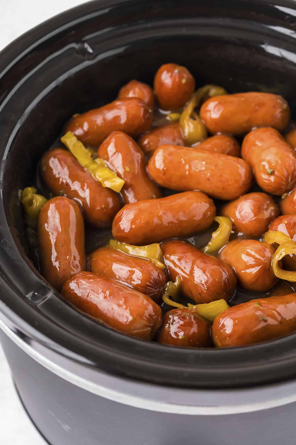 Lil smokies sausages in crockpot with peppers.