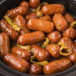 Lil smokies in gravy in a crockpot.