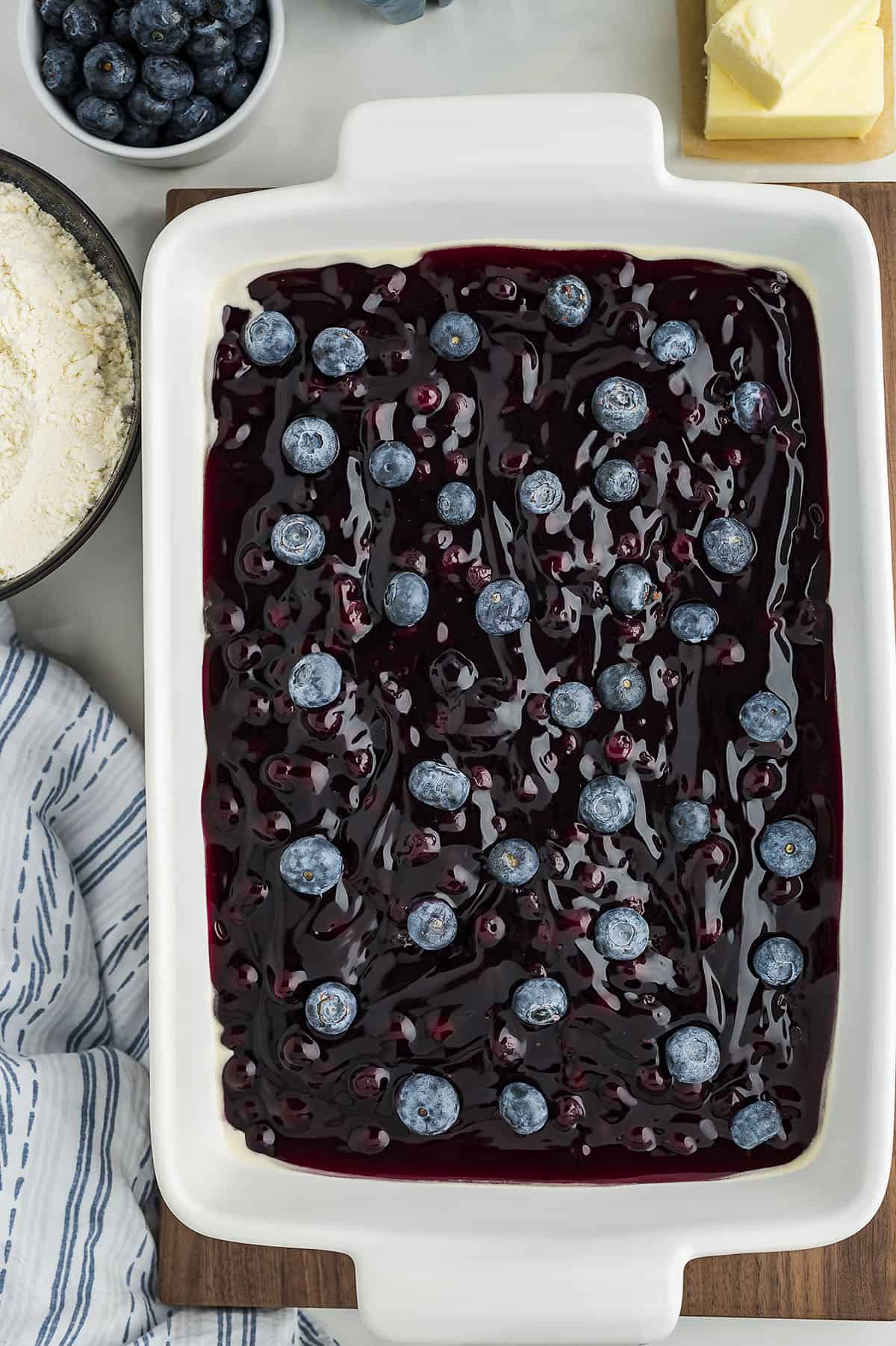 Blueberry pie filling and fresh blueberries in 9x13 baking dish.