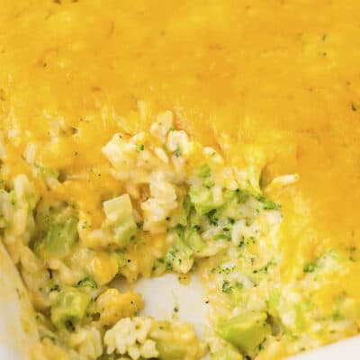 White baking dish full of cheesy broccoli rice casserole.