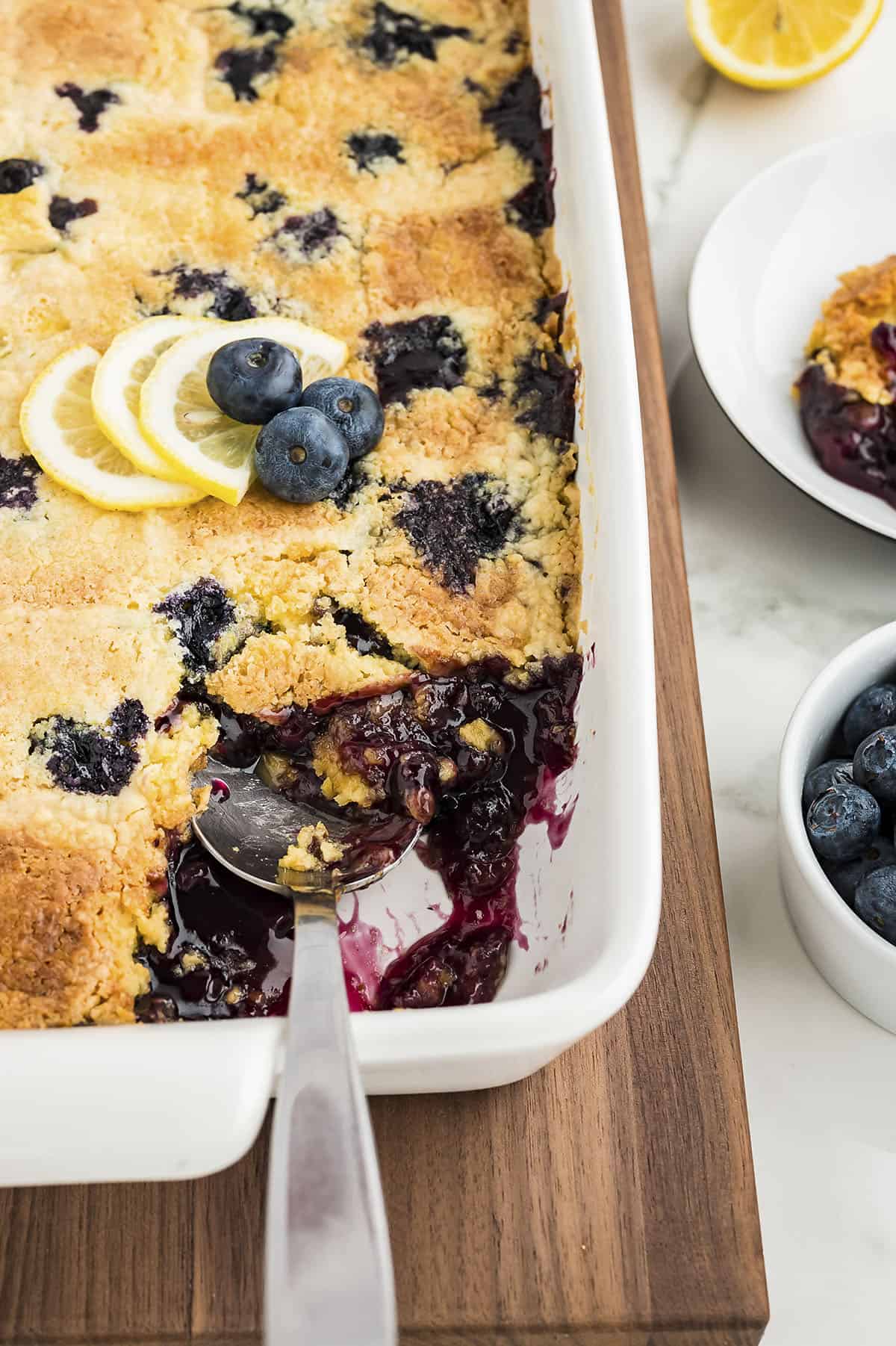 Lemon blueberry dump cake in white 9x13 baking dish.