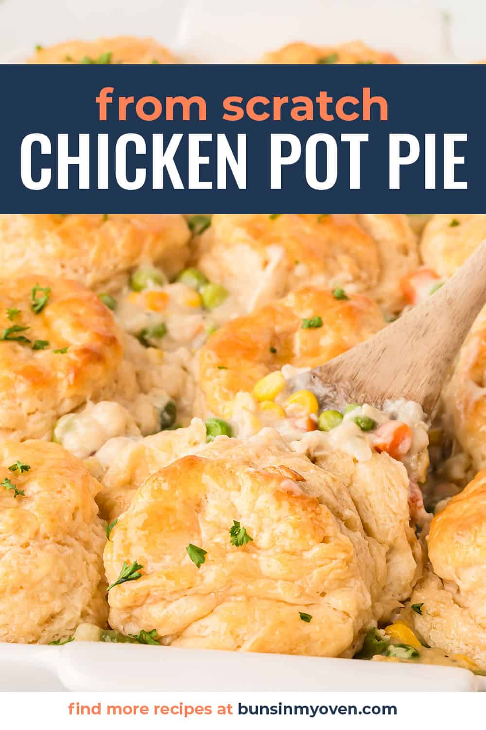 Chicken pot pie with biscuits in white casserole dish.